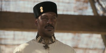 Movie still from “Coming 2 America” (2021), directed by Craig Brewer – A man wearing a black hat and a white shirt; Close Up shot, Low angle