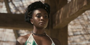 Movie still from “Coming 2 America” (2021), directed by Craig Brewer – A beautiful young woman with a green and white dress; Close Up shot, Low angle