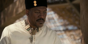 Movie still from “Coming 2 America” (2021), directed by Craig Brewer – A man wearing a white shirt and a black hat; Close Up shot, Low angle