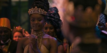 Movie still from “Coming 2 America” (2021), directed by Craig Brewer – A group of people in a room with lights on; Close Up shot, Over the shoulder angle