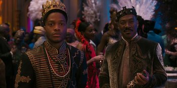 Movie still from “Coming 2 America” (2021), directed by Craig Brewer – A couple of men standing next to each other in a room; Medium shot, Over the shoulder angle