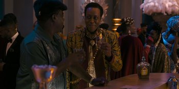 Movie still from “Coming 2 America” (2021), directed by Craig Brewer – Two men are drinking at a bar together; Medium shot, Over the shoulder angle