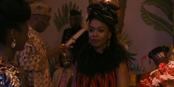 Movie still from “Coming 2 America” (2021), directed by Craig Brewer – A woman with a dreads is holding a glass of wine; Close Up shot, Over the shoulder angle