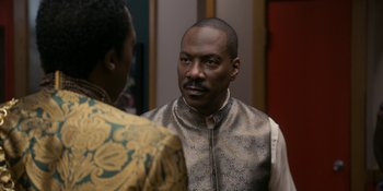Movie still from “Coming 2 America” (2021), directed by Craig Brewer – A man and a woman standing next to each other in a room; Close Up shot, Over the shoulder angle