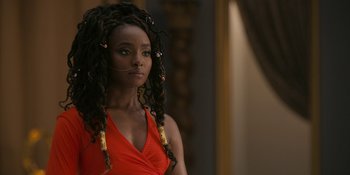 Movie still from “Coming 2 America” (2021), directed by Craig Brewer – A woman in a red dress with dreadlocks; Close Up shot, Over the shoulder angle