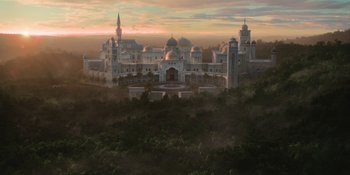 Movie still from “Coming 2 America” (2021), directed by Craig Brewer – An aerial view of a large building in the middle of a forest; Extreme Wide shot, Low angle