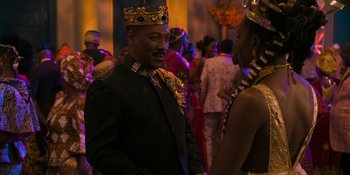 Movie still from “Coming 2 America” (2021), directed by Craig Brewer – A man in a suit and a crown talking to a woman in a crown; Medium shot, Over the shoulder angle