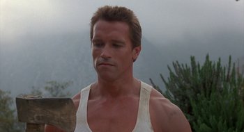 Movie still from “Commando” (1985), directed by Mark L. Lester – A person holding a hammer; Close Up shot, Low angle