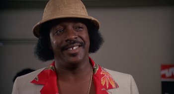 Movie still from “Commando” (1985), directed by Mark L. Lester – A person wearing a hat; Close Up shot, Low angle