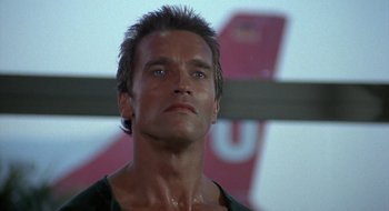 Movie still from “Commando” (1985), directed by Mark L. Lester – A man that is looking at the camera; Close Up shot, Low angle