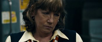 Movie still from “Compliance” (2012), directed by Craig Zobel – A person wearing a jacket; Close Up shot, Over the shoulder angle