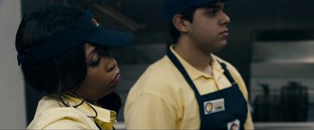 Movie still from “Compliance” (2012), directed by Craig Zobel – A man and a woman standing next to each other; Close Up shot, Over the shoulder angle