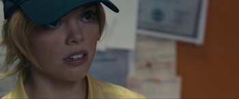 Movie still from “Compliance” (2012), directed by Craig Zobel – A person wearing a hat; Close Up shot, Over the shoulder angle