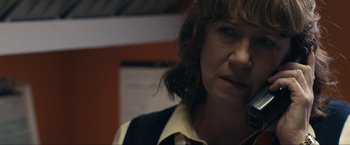 Movie still from “Compliance” (2012), directed by Craig Zobel – A person wearing a shirt and tie; Close Up shot, Over the shoulder angle