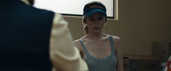 Movie still from “Compliance” (2012), directed by Craig Zobel – A woman wearing a blue hat looking into a mirror; Close Up shot, Over the shoulder angle