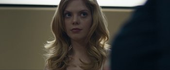 Movie still from “Compliance” (2012), directed by Craig Zobel – A beautiful young woman with long , blonde hair; Close Up shot, Over the shoulder angle
