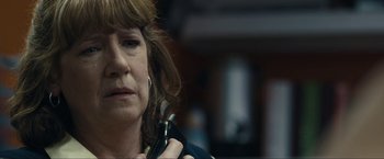 Movie still from “Compliance” (2012), directed by Craig Zobel – A person holding a cell phone; Close Up shot, Over the shoulder angle