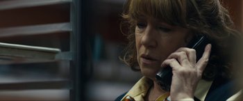 Movie still from “Compliance” (2012), directed by Craig Zobel – A person talking on a cell phone; Close Up shot, Low angle