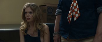 Movie still from “Compliance” (2012), directed by Craig Zobel – A woman sitting next to a man in a room; Close Up shot, Over the shoulder angle