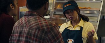 Movie still from “Compliance” (2012), directed by Craig Zobel – A woman wearing a hat is talking to a man in a plaid shirt; Close Up shot, Over the shoulder angle