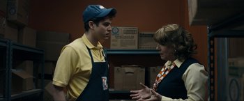 Movie still from “Compliance” (2012), directed by Craig Zobel – A man and a woman are talking in a room; Medium shot, Over the shoulder angle