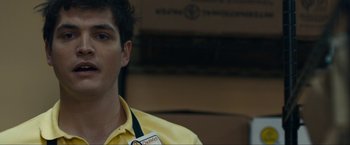 Movie still from “Compliance” (2012), directed by Craig Zobel – A man in a yellow shirt is looking to his left; Close Up shot, Over the shoulder angle