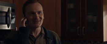 Movie still from “Compliance” (2012), directed by Craig Zobel – A person smiling for the camera; Close Up shot, Over the shoulder angle