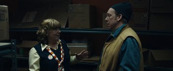 Movie still from “Compliance” (2012), directed by Craig Zobel – A man and a woman are talking in a room; Medium shot, Over the shoulder angle