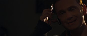 Movie still from “Compliance” (2012), directed by Craig Zobel – A person holding a cell phone in their hand; Close Up shot, Low angle
