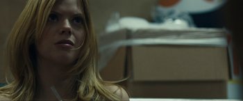 Movie still from “Compliance” (2012), directed by Craig Zobel – A person sitting in a room; Close Up shot, Low angle