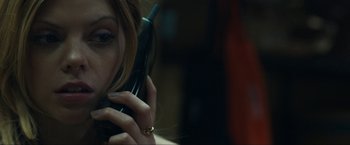 Movie still from “Compliance” (2012), directed by Craig Zobel – A person talking on a cell phone; Close Up shot, Over the shoulder angle