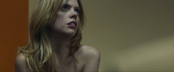 Movie still from “Compliance” (2012), directed by Craig Zobel – A beautiful woman with long blonde hair and blue eyes; Close Up shot, Low angle