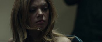 Movie still from “Compliance” (2012), directed by Craig Zobel – A person with long blonde hair; Close Up shot, Over the shoulder angle