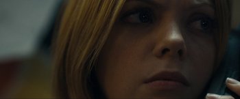Movie still from “Compliance” (2012), directed by Craig Zobel – A woman's eyes and hair; Extreme Close Up shot, Over the shoulder angle