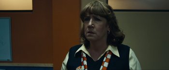 Movie still from “Compliance” (2012), directed by Craig Zobel – A person wearing a shirt and tie; Close Up shot, Over the shoulder angle