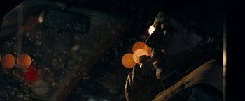 Movie still from “Compliance” (2012), directed by Craig Zobel – A person holding a piece of pizza in their hand; Close Up shot, Over the shoulder angle