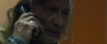 Movie still from “Compliance” (2012), directed by Craig Zobel – An older man talking on a cell phone; Close Up shot, Over the shoulder angle