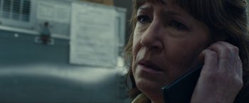 Movie still from “Compliance” (2012), directed by Craig Zobel – An older woman talking on a phone in a room; Close Up shot, Low angle