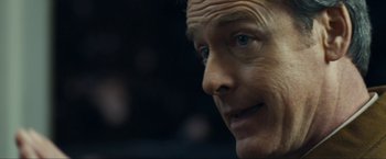 Movie still from “Compliance” (2012), directed by Craig Zobel – A man's face in a dark room; Extreme Close Up shot, Over the shoulder angle