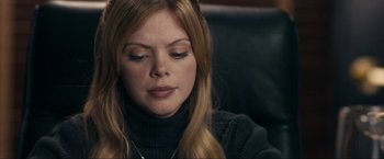 Movie still from “Compliance” (2012), directed by Craig Zobel – A person sitting down with her eyes closed; Close Up shot, High angle