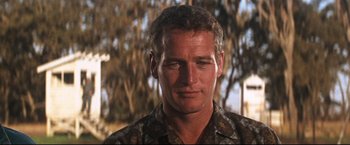 Movie still from “Cool Hand Luke” (1967), directed by Stuart Rosenberg – A person wearing a camouflage shirt; Close Up shot, Low angle