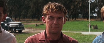 Movie still from “Cool Hand Luke” (1967), directed by Stuart Rosenberg – A person wearing a red shirt; Close Up shot, Low angle