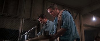 Movie still from “Cool Hand Luke” (1967), directed by Stuart Rosenberg – A couple of men standing next to each other in a building; Medium shot, Low angle