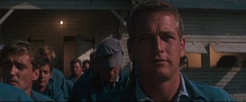Movie still from “Cool Hand Luke” (1967), directed by Stuart Rosenberg – A group of men standing next to each other in front of a building; Close Up shot, Low angle