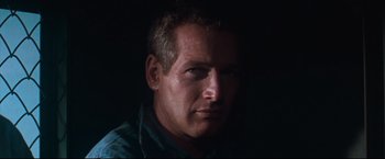 Movie still from “Cool Hand Luke” (1967), directed by Stuart Rosenberg – A person wearing a blue shirt; Close Up shot, Low angle