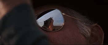 Movie still from “Cool Hand Luke” (1967), directed by Stuart Rosenberg – The reflection of a person in a pair of sunglasses; Extreme Close Up shot, Over the shoulder angle