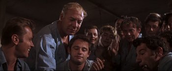 Movie still from “Cool Hand Luke” (1967), directed by Stuart Rosenberg – A group of men standing next to each other in a room; Medium shot, Low angle