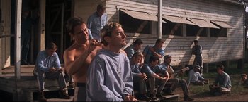Movie still from “Cool Hand Luke” (1967), directed by Stuart Rosenberg – A group of men standing next to each other on a porch; Medium shot, Low angle