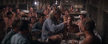 Movie still from “Cool Hand Luke” (1967), directed by Stuart Rosenberg – A group of men sitting in a room; Wide shot, High angle
