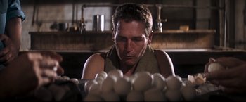Movie still from “Cool Hand Luke” (1967), directed by Stuart Rosenberg – A man looking at a pile of eggs in a kitchen; Close Up shot, Low angle